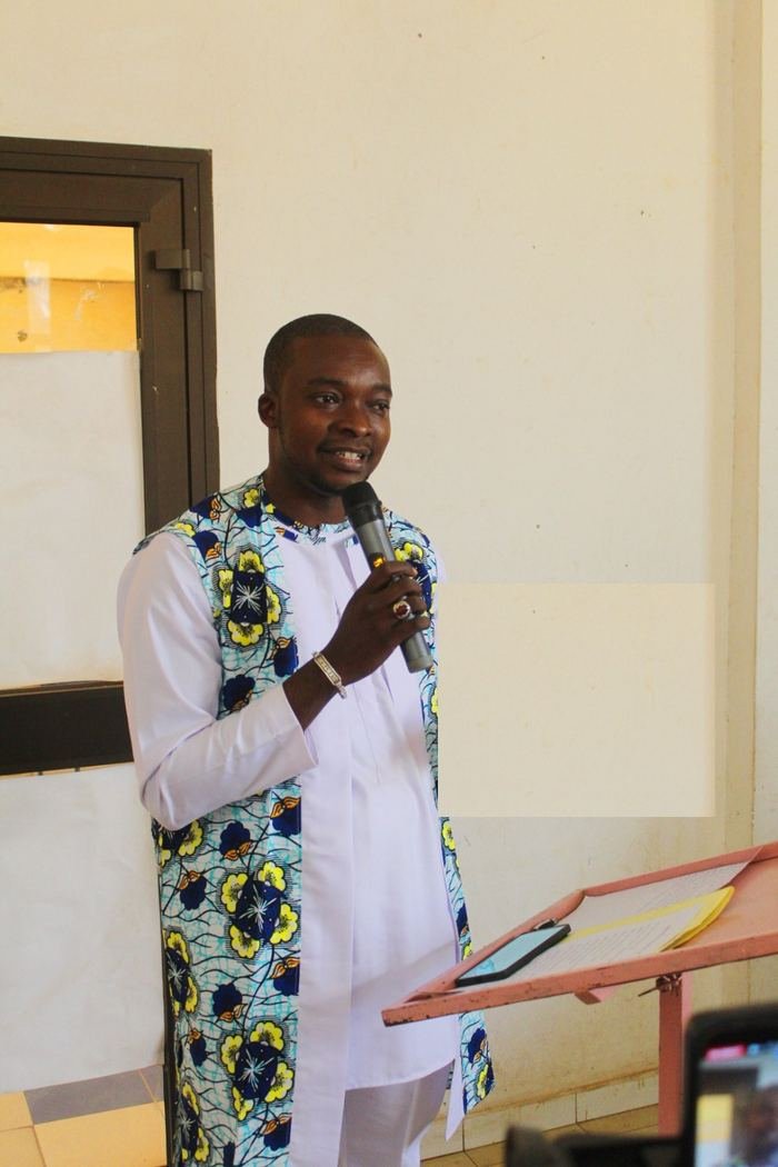 Massedou speaking at the podium